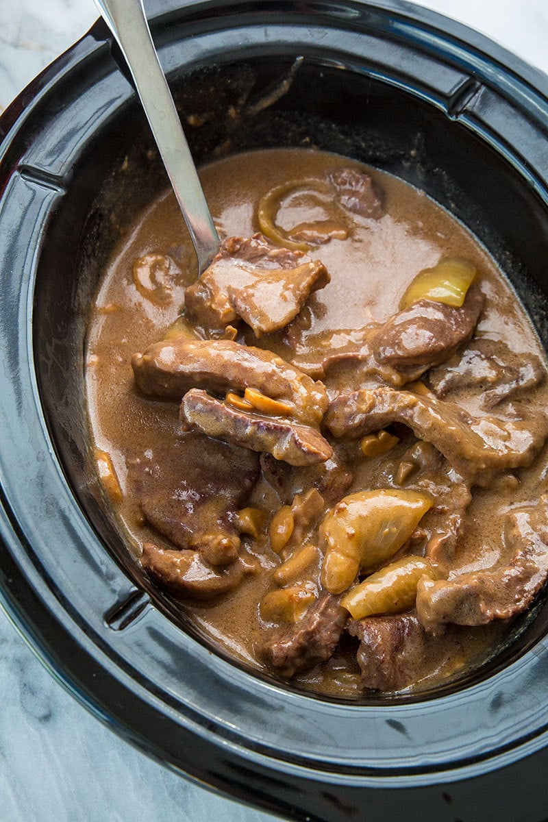 Slow Cooker Cube Steak in the slow cooker with spoon