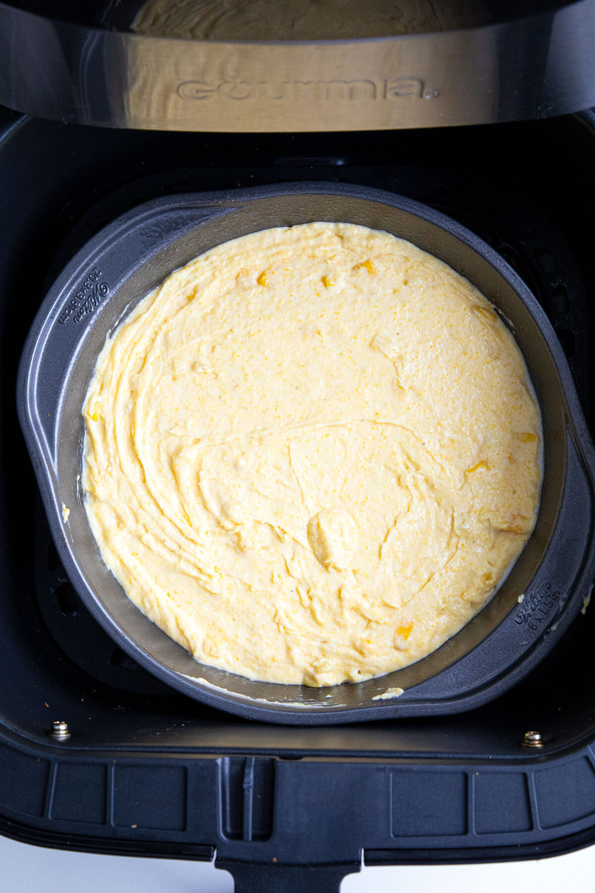 pan of cornbread batter in air fryer basket 