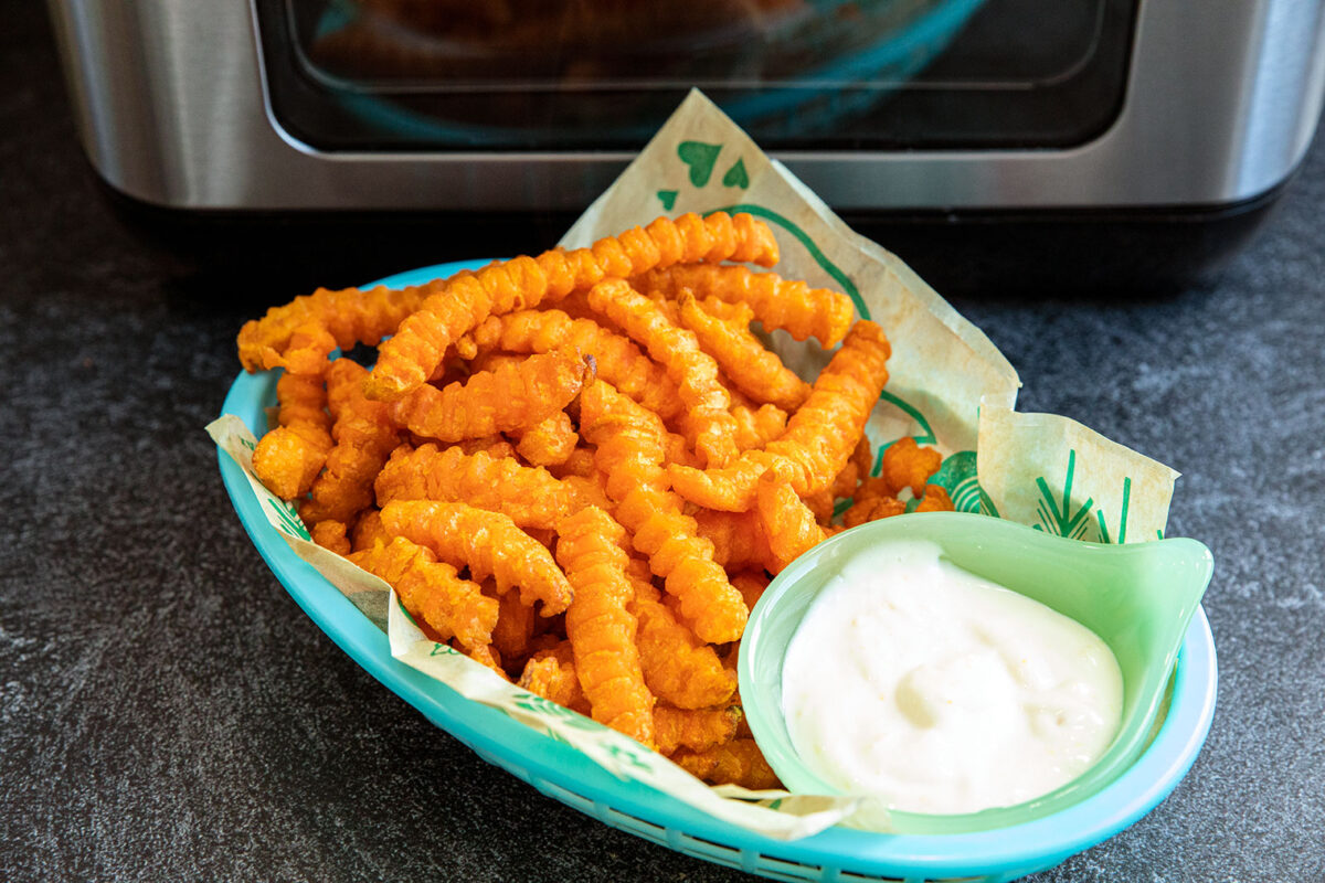 sweet potato fries in a basket with lemon aioli