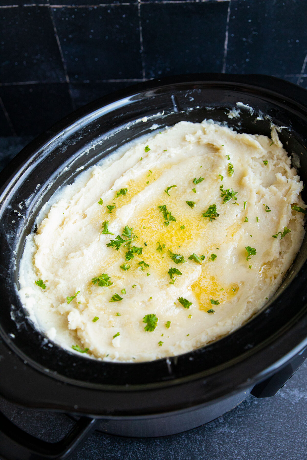 butter melted on top of slow cooker mashed potatoes 