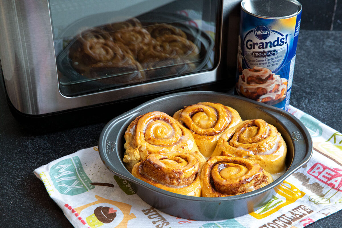 cinnamon rolls in a pan with an air fryer