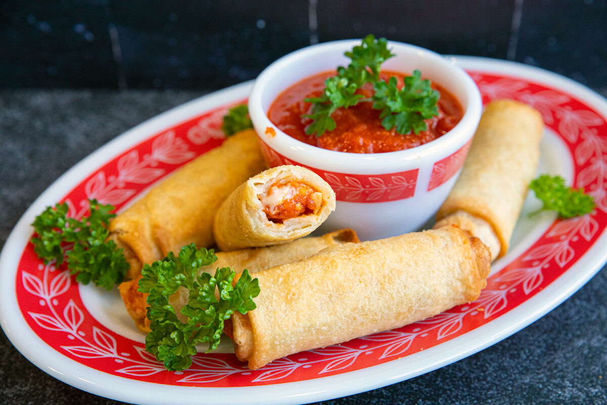 air fryer pizza rolls on a plate with marinara