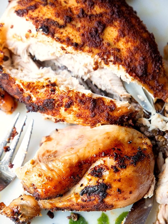 Crockpot rotisserie chicken carved on a plate